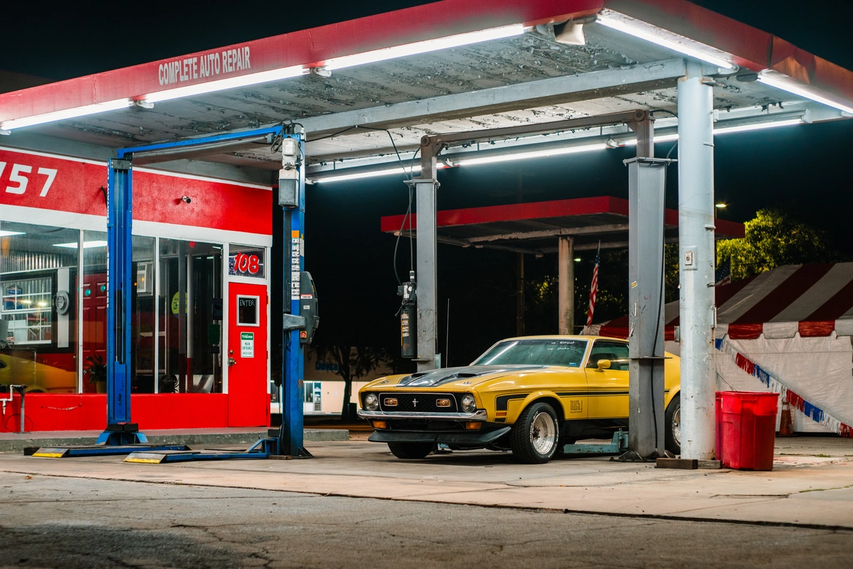 A 1971 Ford Mustang in an outdoor mechanic shop